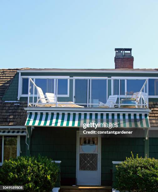 old shingle style beach cottage deck - striped awning stock pictures, royalty-free photos & images