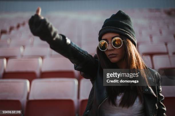 mujer viendo un partido y animando al aire libre - obscene gesture fotografías e imágenes de stock