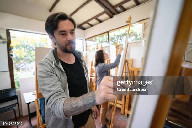 man painting in an art class - art class stock pictures, royalty-free photos & images