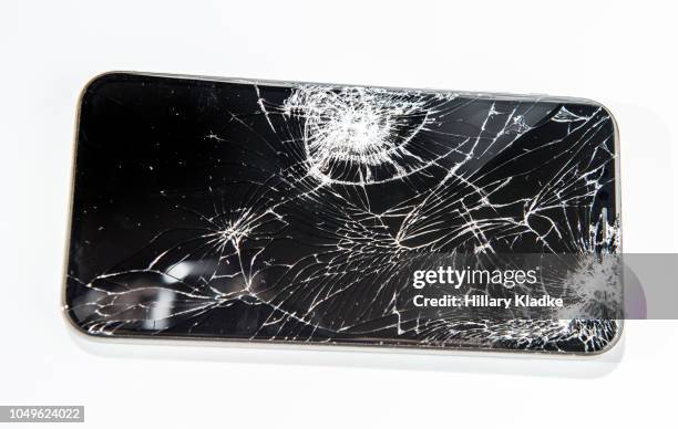 broken phone on white background - broken smartphone fotografías e imágenes de stock