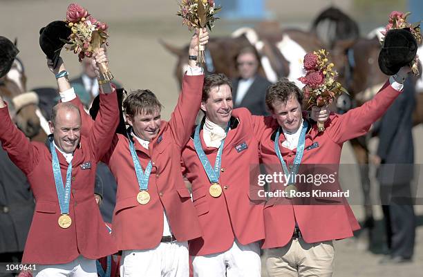 The Australian team of Matt Ryan, Phillip Dutton, Stuart Tinney and Andrew Hoy celebrate winning Gold in the final of the Team Three Day event at the...