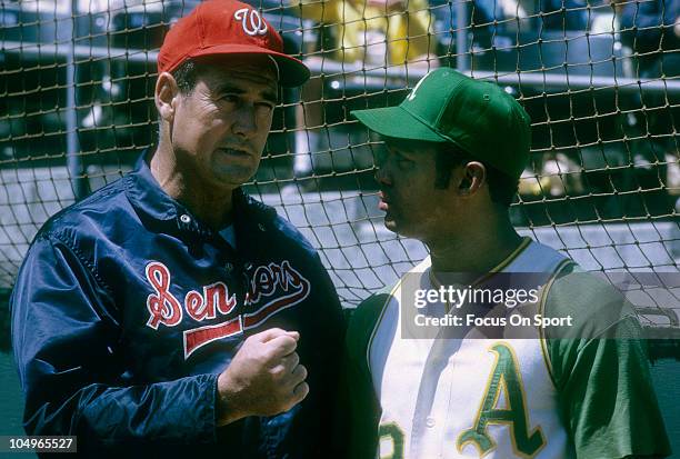 Outfielder Reggie Jackson of the Oakland Athletics talks with manager Ted Williams of the Washington Senators before a Major League Baseball game...