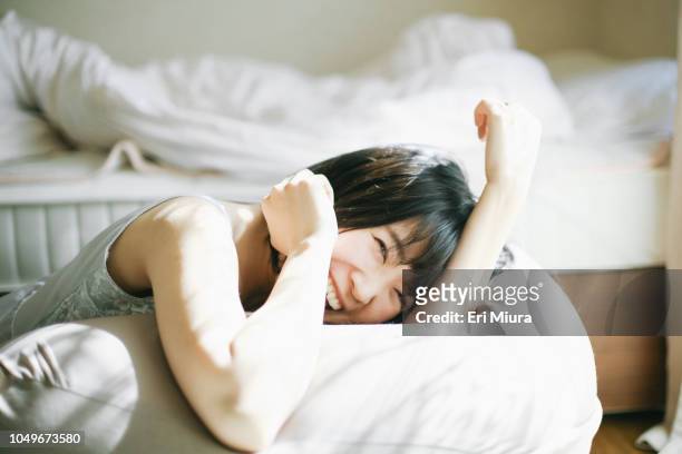 a woman relaxing in the room - 日本人　笑顔　女性 ストックフォトと画像