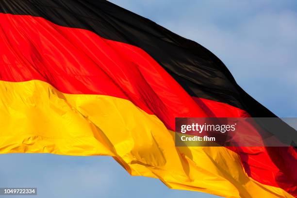 german flag with dramatic sky (berlin, germany) - german flag wallpaper stock pictures, royalty-free photos & images