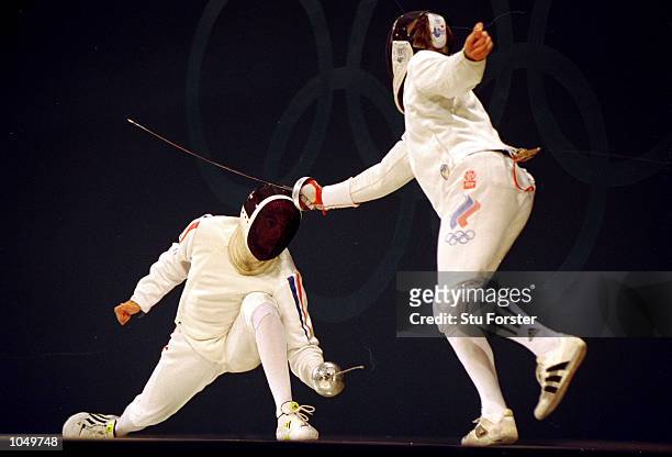 Pavel Kolobkov of Russia on his way to winning Gold in the Mens Fencing Individual Epee against Silver Medallist Hugues Obry of France from the...