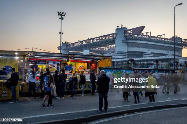 Fans gather around food stalls outside San Siro stadium before the Milan derby between Inter Milan and city rival’s AC Milan on October 15, 2018 in...