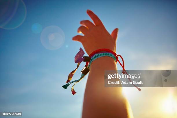 music festival hand waving - bracelet festival photos et images de collection