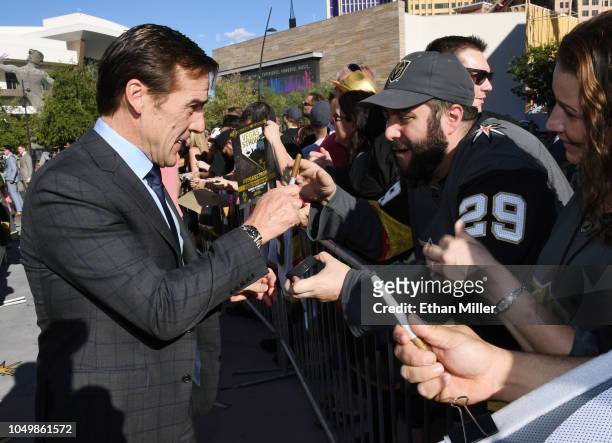 Vegas Golden Knights President of Hockey Operations and general manager George McPhee signs autographs for fans as he arrives at the team's home...