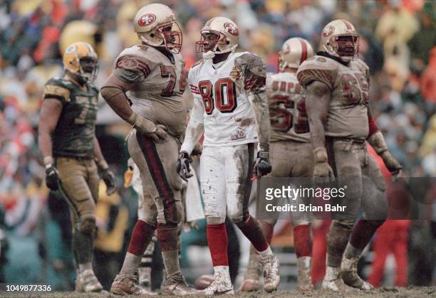 Wide receiver Jerry Rice of the San Francisco 49ers confers with teammates Ray Brown and Steve Wallace during the NFC Divisional playoff game against...