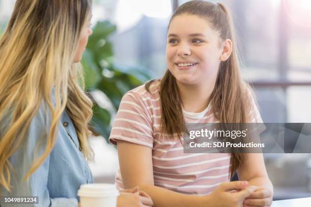 cheerful teenage girl talks with her mom - child psychologist stock pictures, royalty-free photos & images
