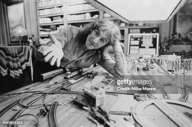 English musician, singer, songwriter and guitarist Denny Laine with a model railway layout, UK, 25th September 1979.