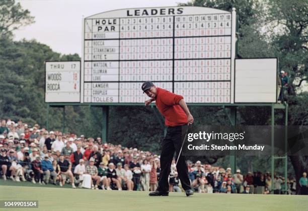 Tiger Woods of the United States celebrates after sinking a 4 feet putt to win the US Masters Golf Tournament with a record low score of 18 under par...