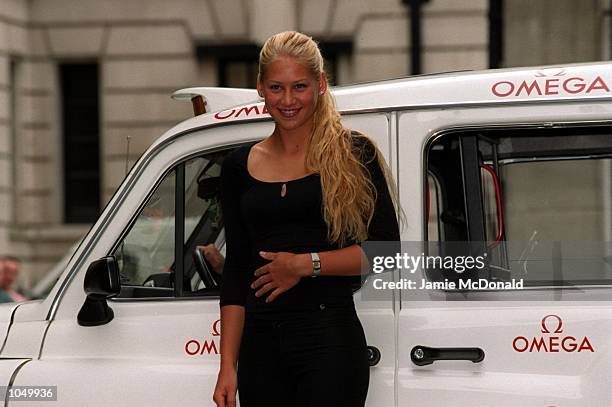 Anna Kournikova of Russia poses with an Omega taxi at a press conference to announce her new partnership with Omega, held at the Grosvenor House...