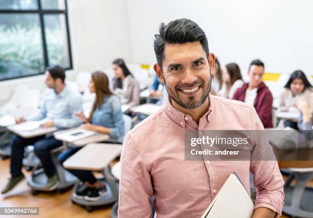 happy man in a classroom with a group of students - pedagoga imagens e fotografias de stock