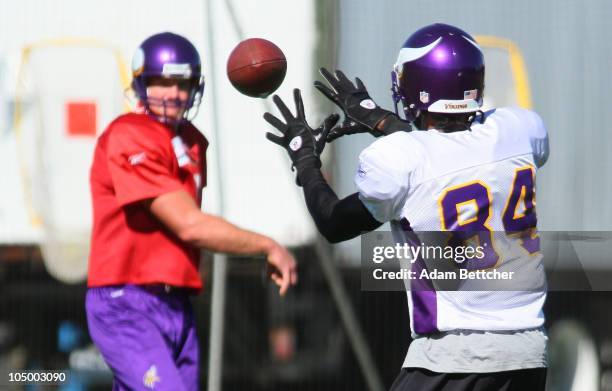 Wide receiver Randy Moss of the Minnesota Vikings catches a ball thrown by Brett Favre during his first practice after re-joining the Vikings at...