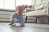 little baby boy crawling on floor at home