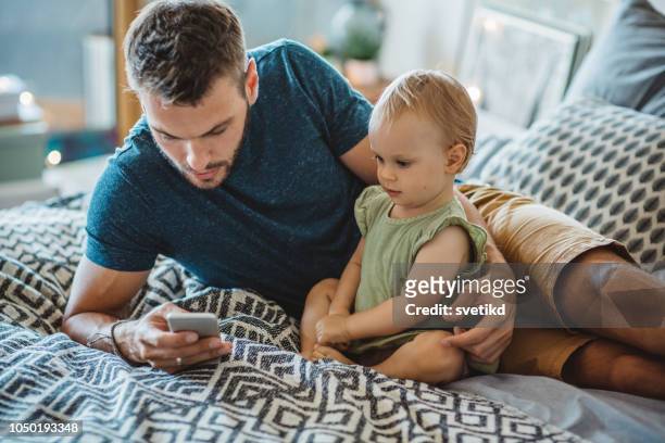 父親在電話裡給小女兒看點東西 - baby mobile 個照片及圖片檔
