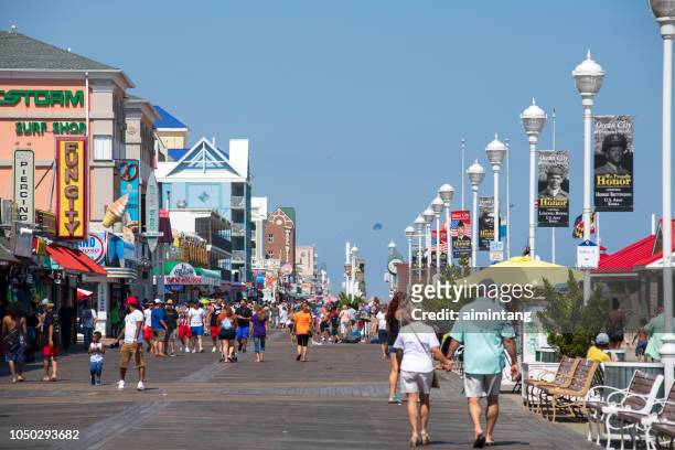 visitors walking on boardwalk at ocean city - ocean city maryland stock pictures, royalty-free photos & images