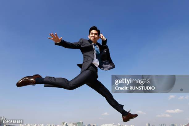 businessman jumping in air - jumping ストックフォトと画像