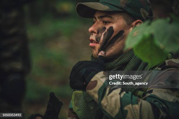 army man preparing for war - army camo stock pictures, royalty-free photos & images