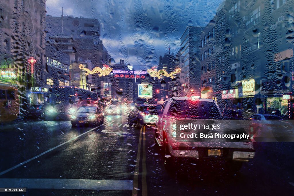 View from dashboard with rain drops of traffic jam in the streets of Manhattan, New York City