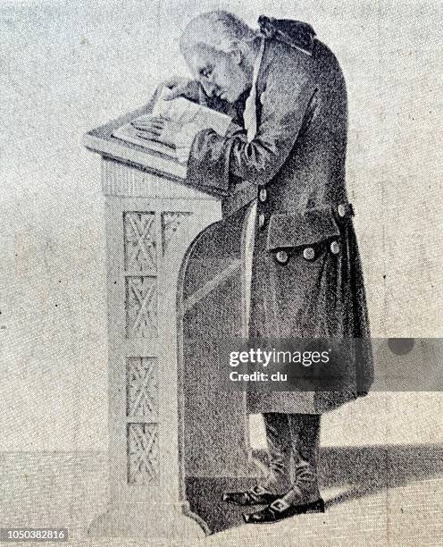 immanuel kant reading a book at his lectern - kant stock illustrations