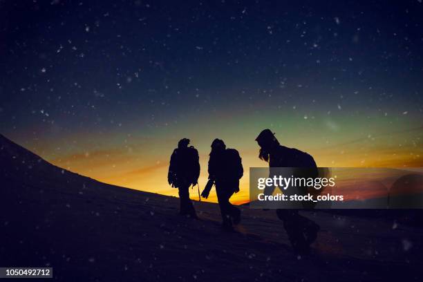 hikers in the sunset - people climbing walking mountain group stock pictures, royalty-free photos & images