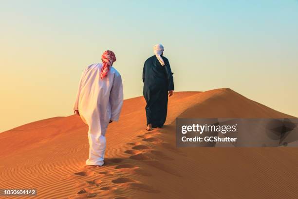 arab youth following the elder brother - saudi arabia desert stock pictures, royalty-free photos & images