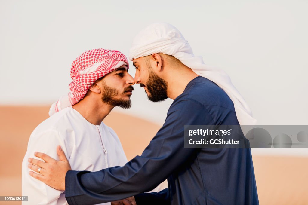 Arab Greeting each other trqditonally at the dunes