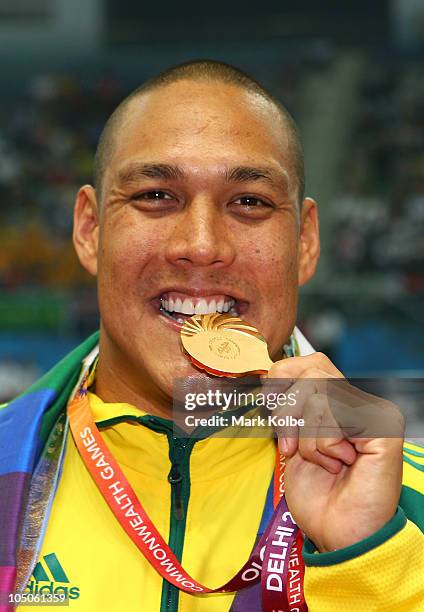 Geoff Huegill of Australia poses with the gold medal during the medal ceremony for the Men's 100m Butterfly Final at Dr. S.P. Mukherjee Aquatics...