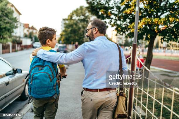 dad's walking him to school today - kids leaving school stock pictures, royalty-free photos & images