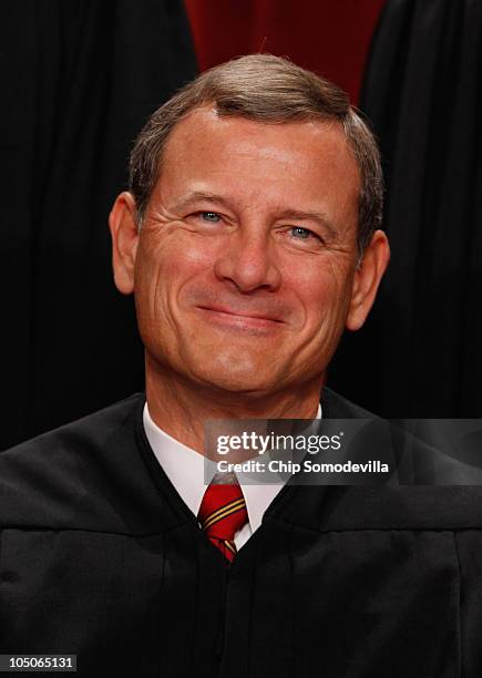 Supreme Court Chief Justice John Roberts poses for photographs in the East Conference Room at the Supreme Court building October 8, 2010 in...