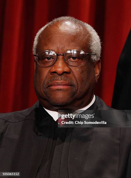 Supreme Court Associate Justice Clarence Thomas poses for photographs in the East Conference Room at the Supreme Court building October 8, 2010 in...