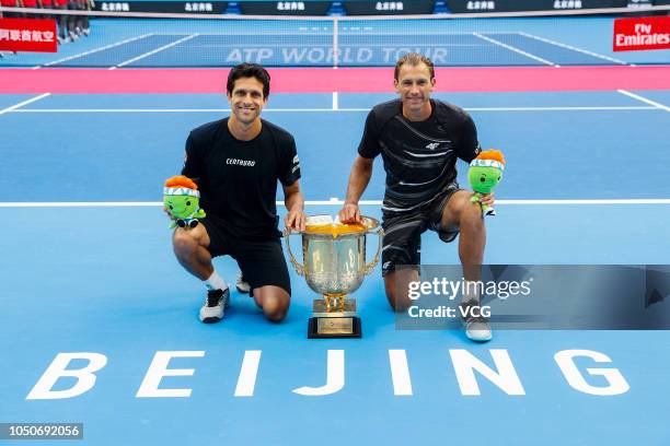 Lukasz Kubot of Poland and Marcelo Melo of Brazil pose with their trophy after winning the Men's doubles final match against Oliver Marach of Austria...