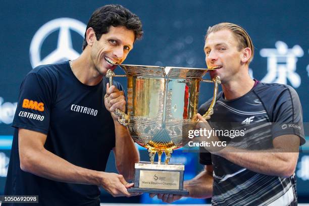 Lukasz Kubot of Poland and Marcelo Melo of Brazil pose with their trophy after winning the Men's doubles final match against Oliver Marach of Austria...