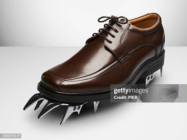 men's business shoe with a climbing crampons - steigeisen stock-fotos und bilder