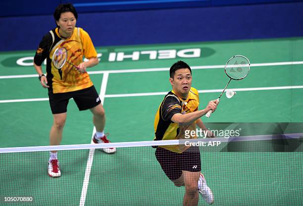 Badminton players Koo Kien Kat and Chin Eh Hui of Malaysia play against Jwala Gutta and Diju Valiya Veetil of India in the mixed double badminton...