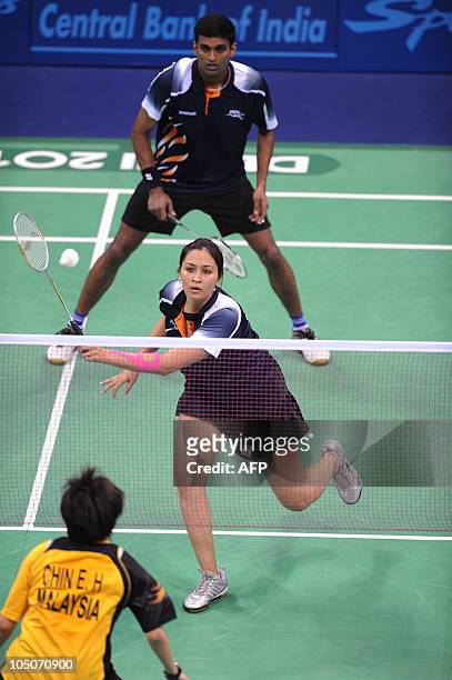 Badminton players Jwala Gutta and Diju Valiya Veetil of India Koo play against unseen Kien Kat and Chin Eh Hui of Malaysia in the mixed double...