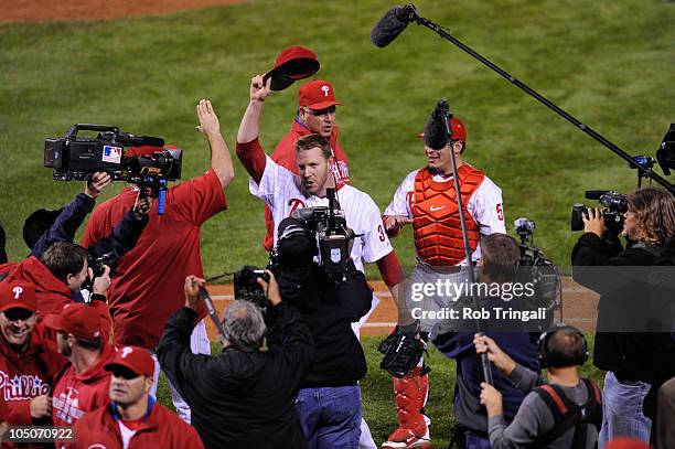 Roy Halladay of the Philadelphia Phillies tips his hat to the crowd after throwing a no hitter against the Cincinnati Reds on October 6, 2010 during...