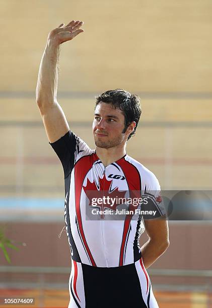 Bronze medallist Zach Bell of Canada celebrates after the 20km scratch cycling race at IG Sports Complex during day five of the Delhi 2010...