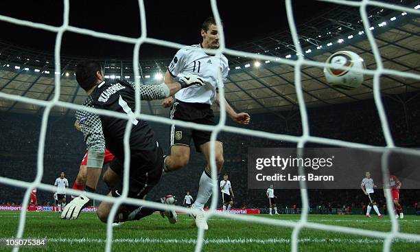 Miroslav Klose of Germany heads the first goal past goalkeeper Volkan Demirel of Turkey during the EURO 2012 Group A qualifier match between Germany...