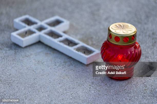 cross and memorial candle - mourning candles stock pictures, royalty-free photos & images