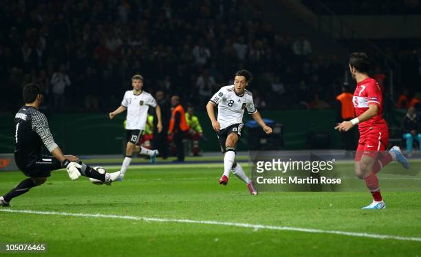 Mesut Oezil of Germany scores his team's 2nd goal during the EURO 2012 Group A qualifier match between Germany and Turkey at Olympia Stadium on...