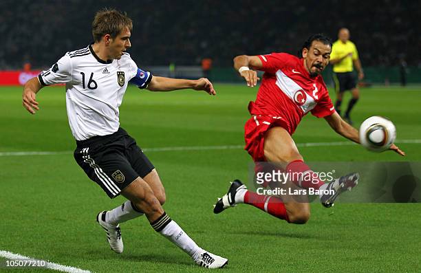 Philipp Lahm of Germany is challenged by Servet Cetin of Turkey during the EURO 2012 Group A qualifier match between Germany and Turkey at Olympic...