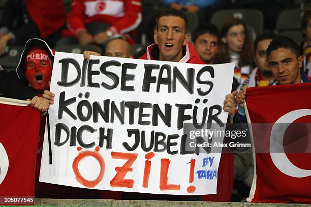 Supporters of Turkey hold up a banner reading 'These fans could cheer for you' before the EURO 2012 group A qualifier match between Germany and...