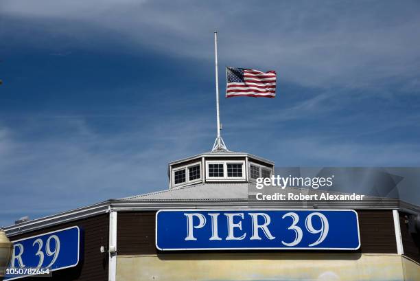An American flag flies at Pier 39, a shopping and restaurant center and tourist attraction in San Francisco, California.