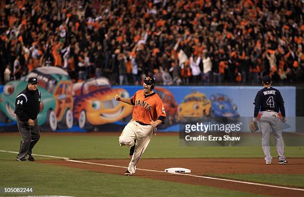 Freddy Sanchez of the San Francisco Giants reacts as he rounds third base on a home run by Pat Burrell in the first inning against the Atlanta Braves...