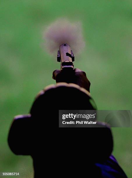 Junior Benskin of Barbados competes in the Mens Pair 25m centrefire pistol event at the Dr Karni Singh Shooting Range during day six of the Delhi...