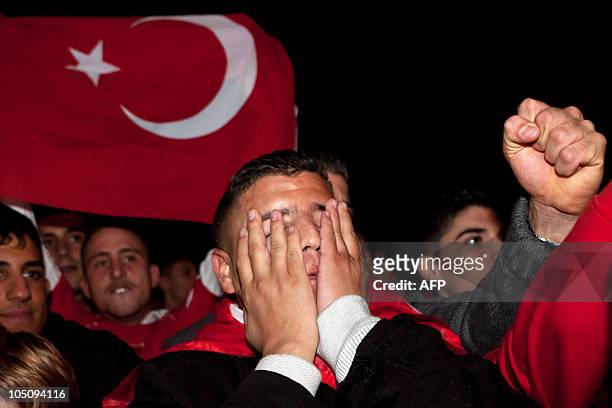 Disappointed fan of the Turkish national football team reacts during the public viewing of the Euro 2012 qualifying football match between Germany...