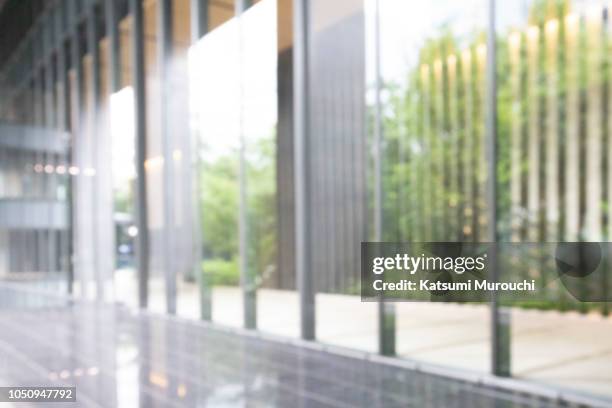 blurred abstract glass wall building background - bokeh stock-fotos und bilder